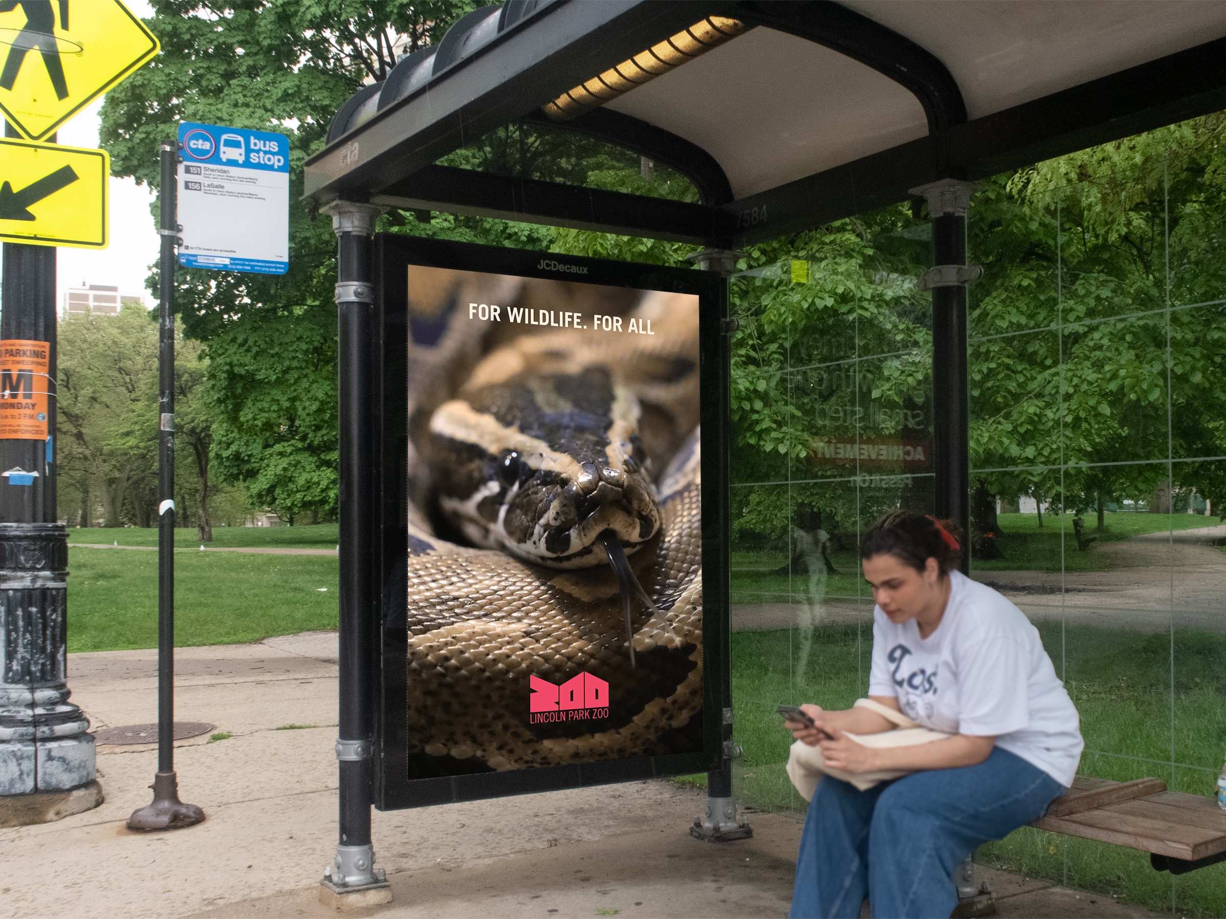 Bus shelter poster with a snake and the line For Wildlife, For All