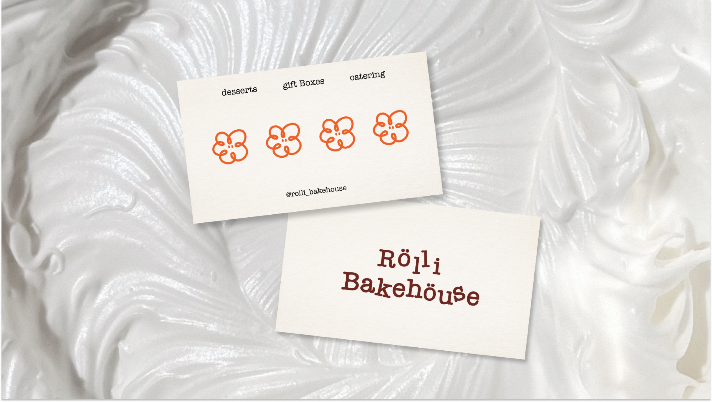 Rolli Bakehouse business cards with the flower logo, laid on whipped cream