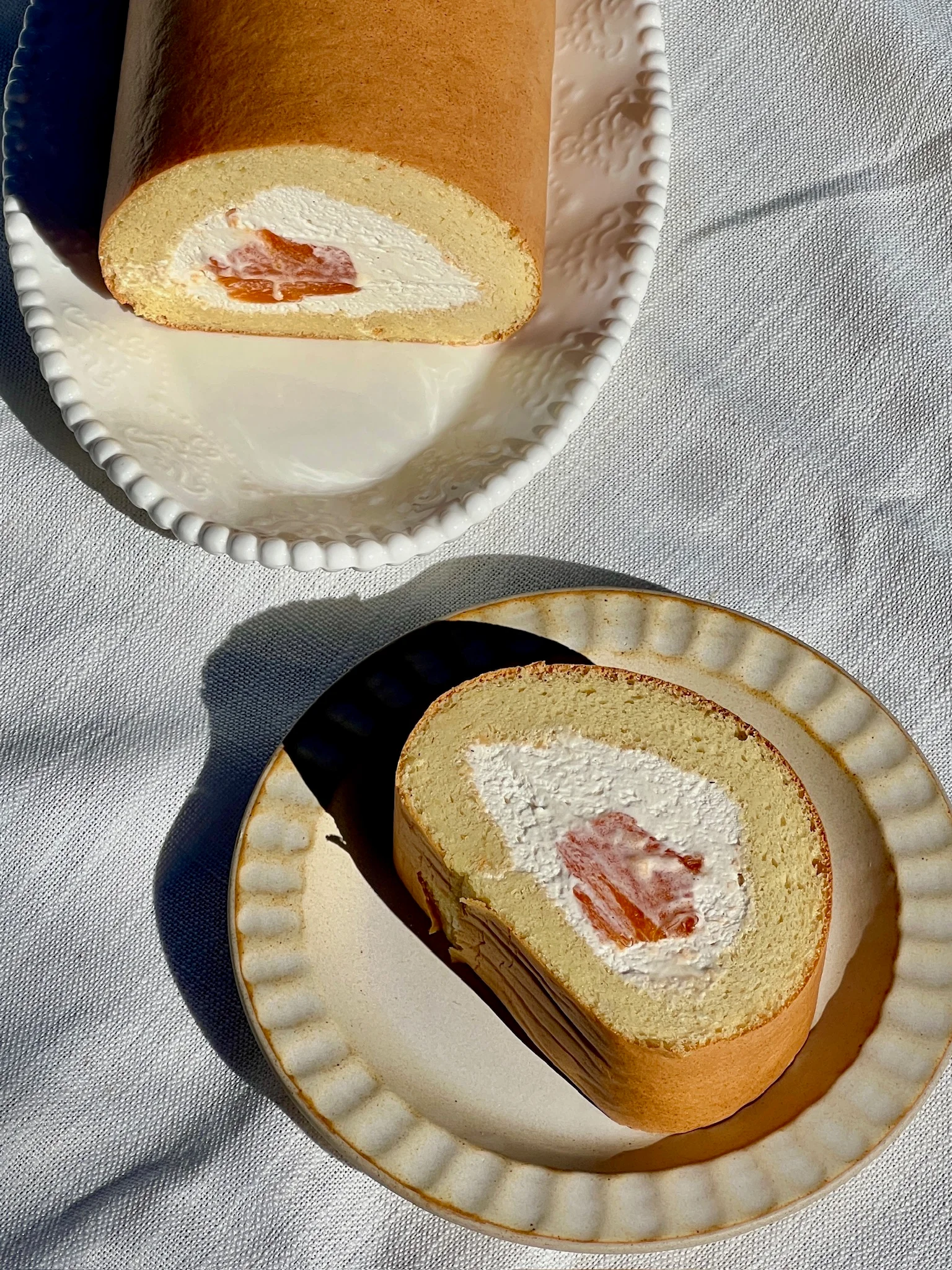 A slice of cake roll on a plate