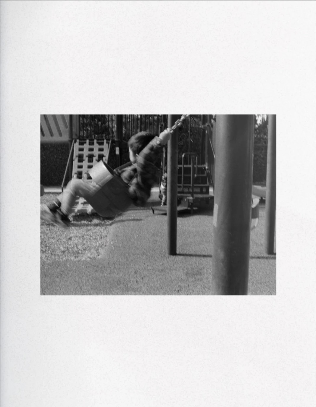 A child on a swing, black and white